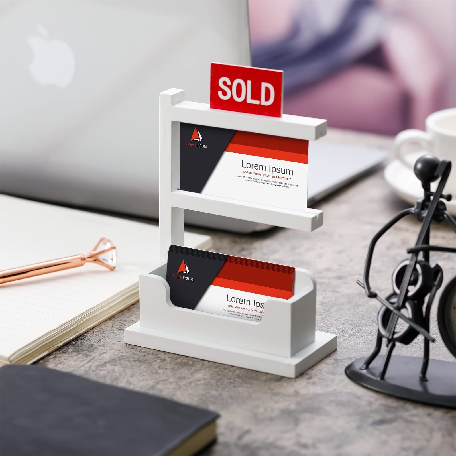 White business card holder with "SOLD" sign, cards, and office supplies